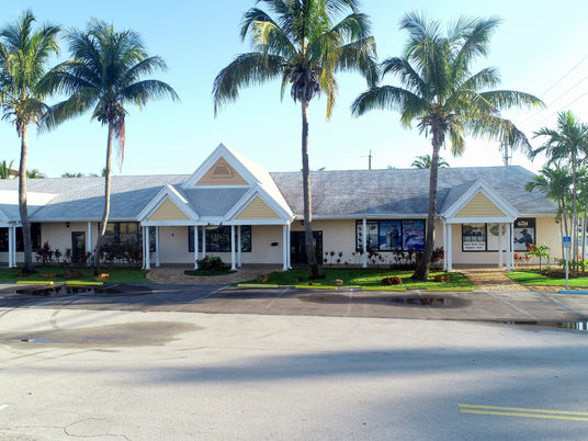 This is a picture of the south entrance to CHAOS' store.  It si a beige building with triangle peeks and a grey roof.