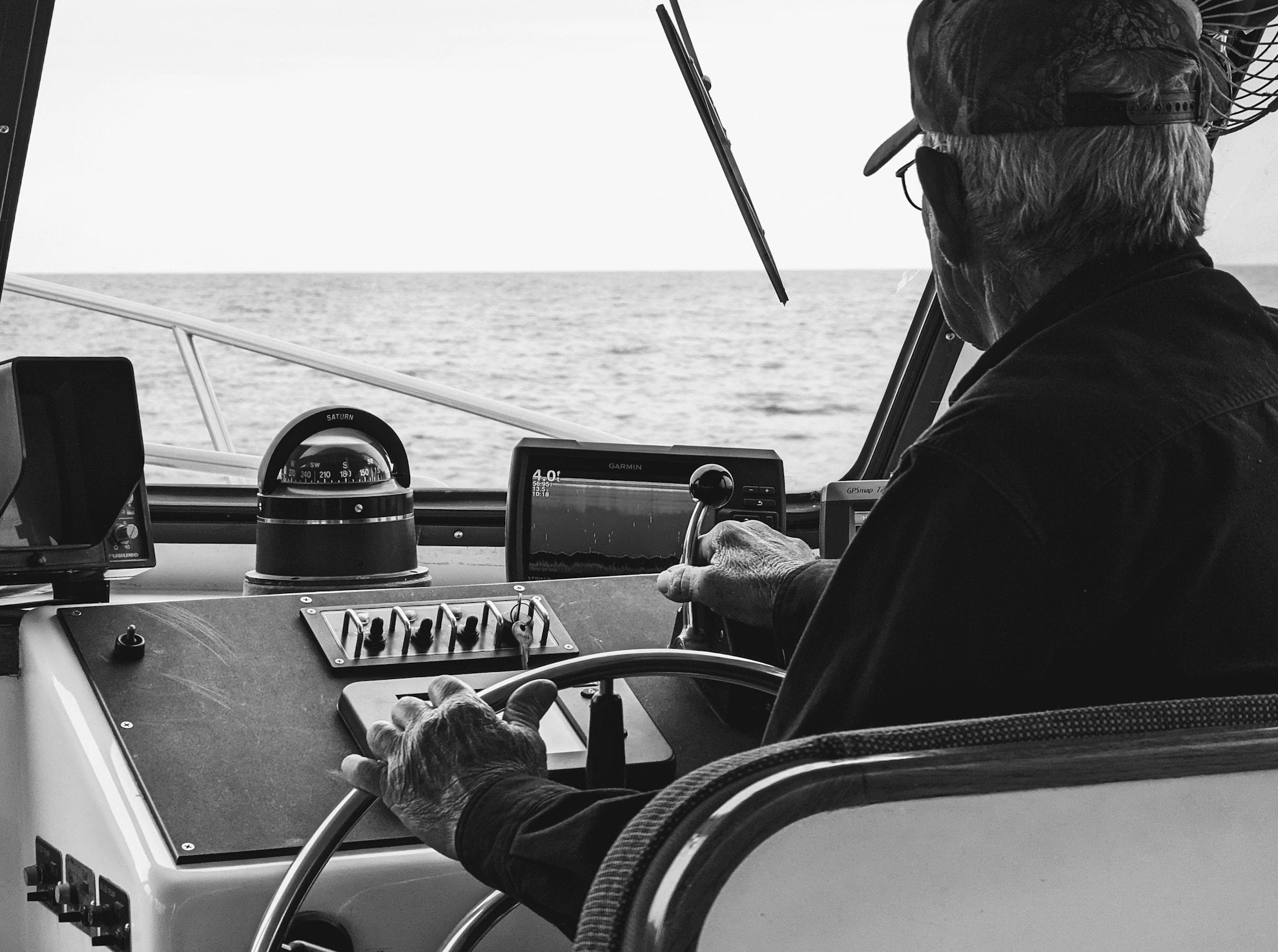 Captain operating a boat at the helm